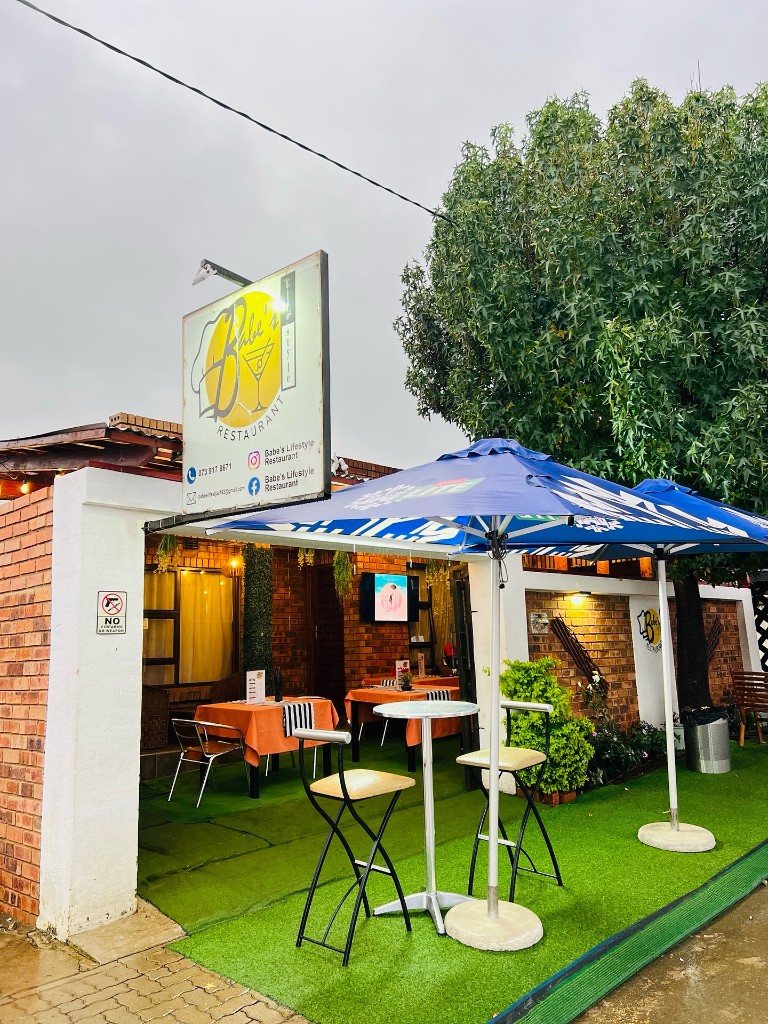 Babe's Lifestyle Restaurant outdoor patio, umbrellas, and entrance signage