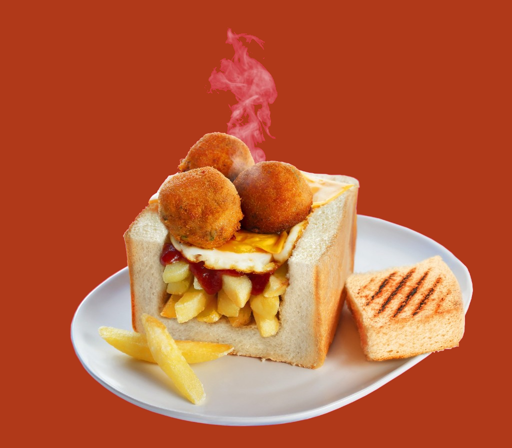 Lucky Chow kota with meatballs, egg, chips, and steam